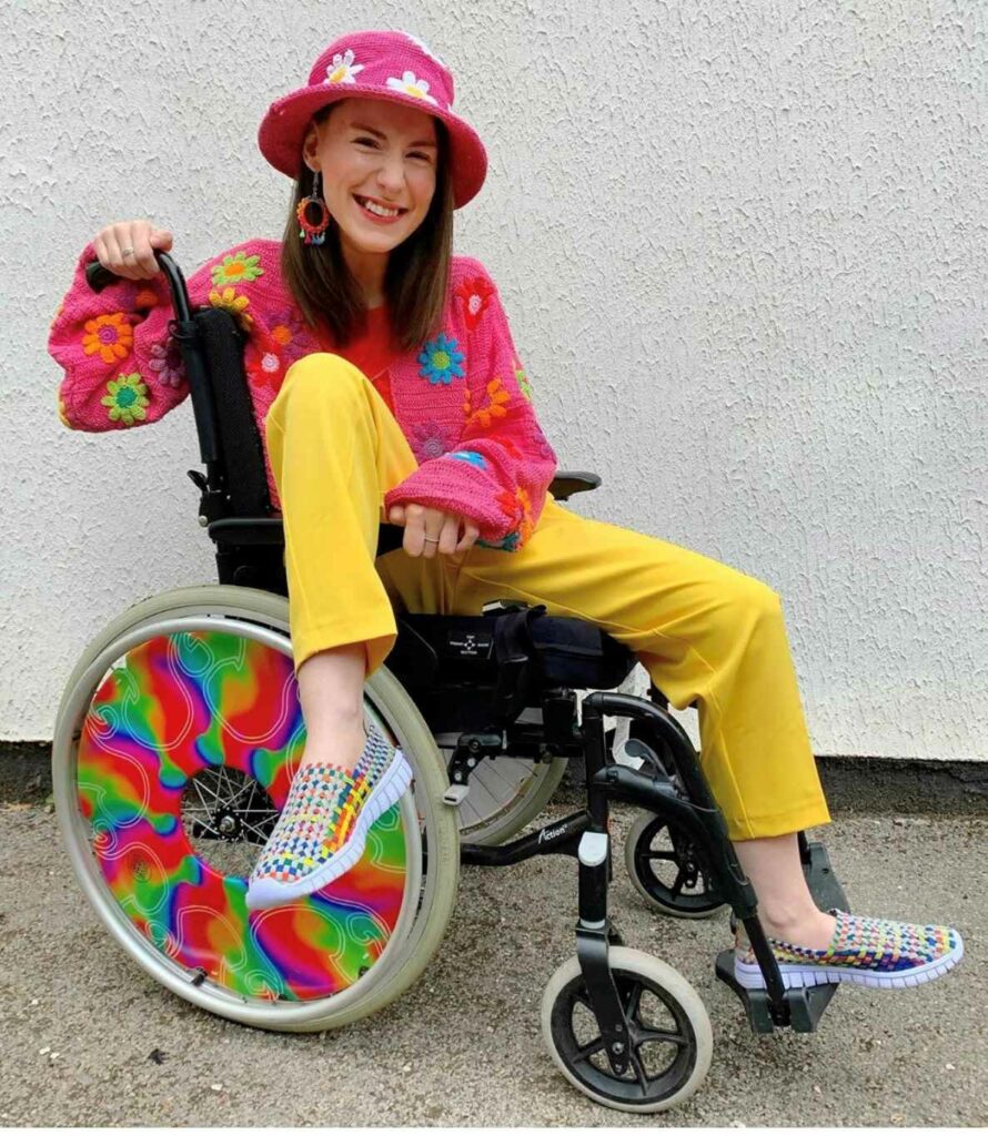 Rebecca, a white woman with brown hair, sitting in her wheelchair